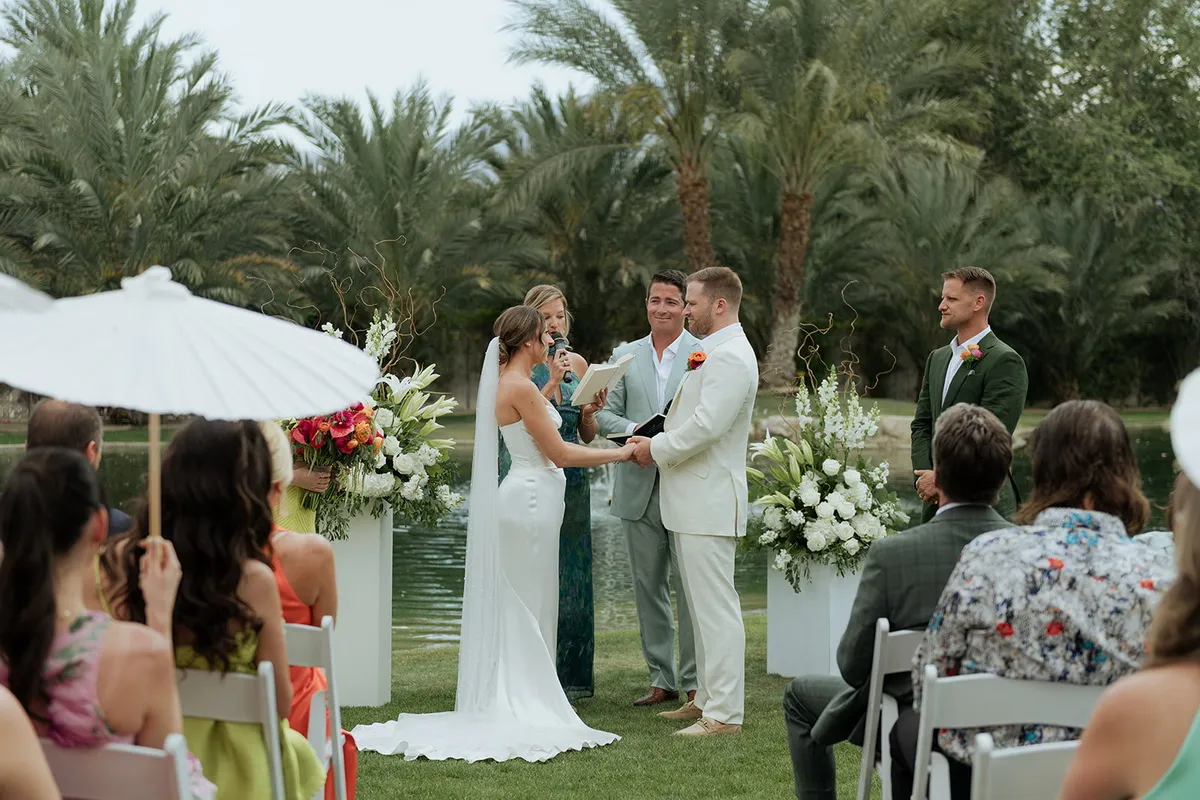 A destination wedding ceremony under the palms in Palm Springs