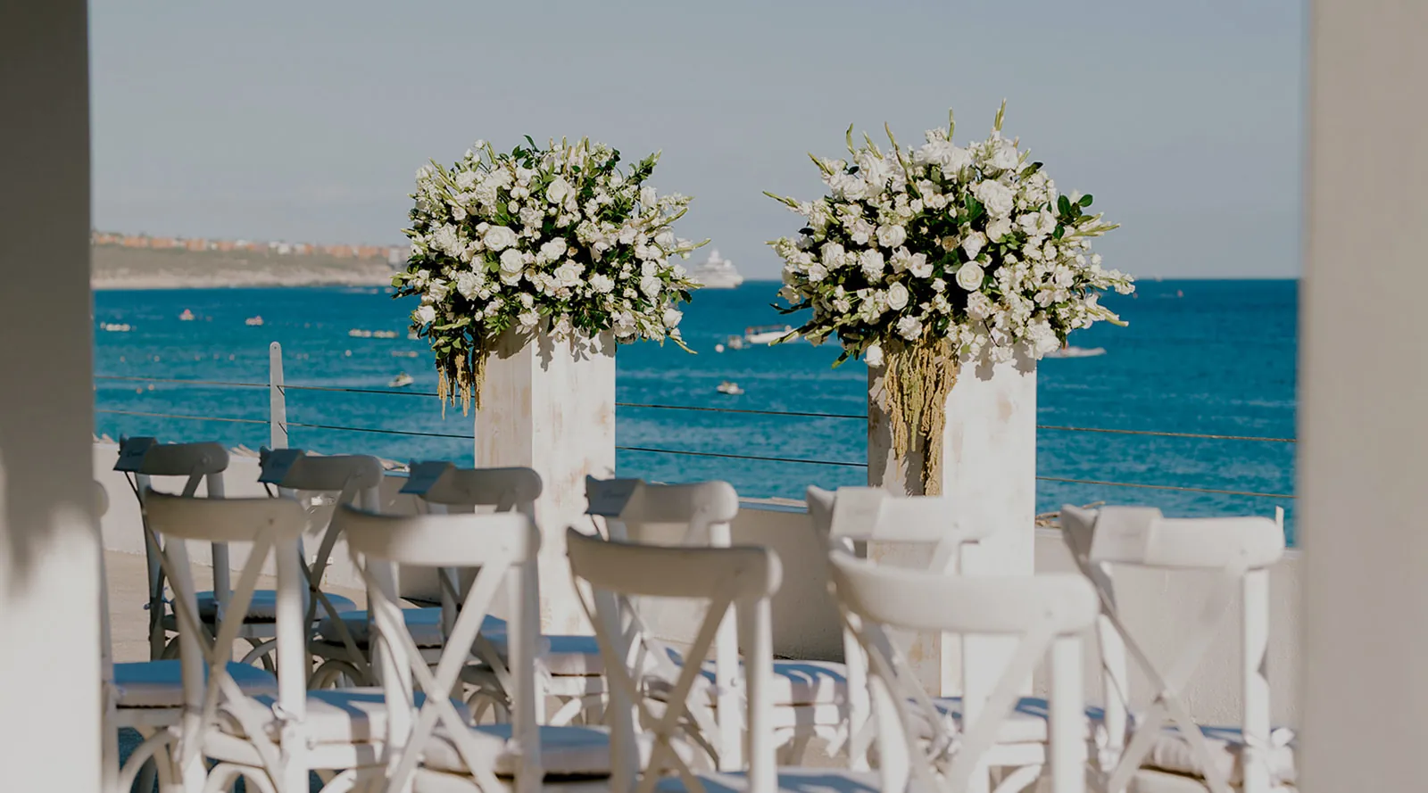 An oceanfront ceremony design with statement florals