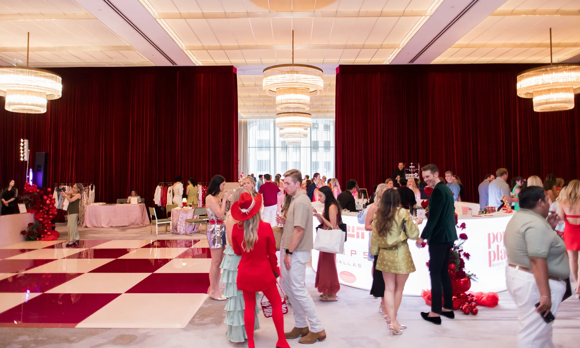 Guests at a Poppy Planning reception around a checkered dance floor