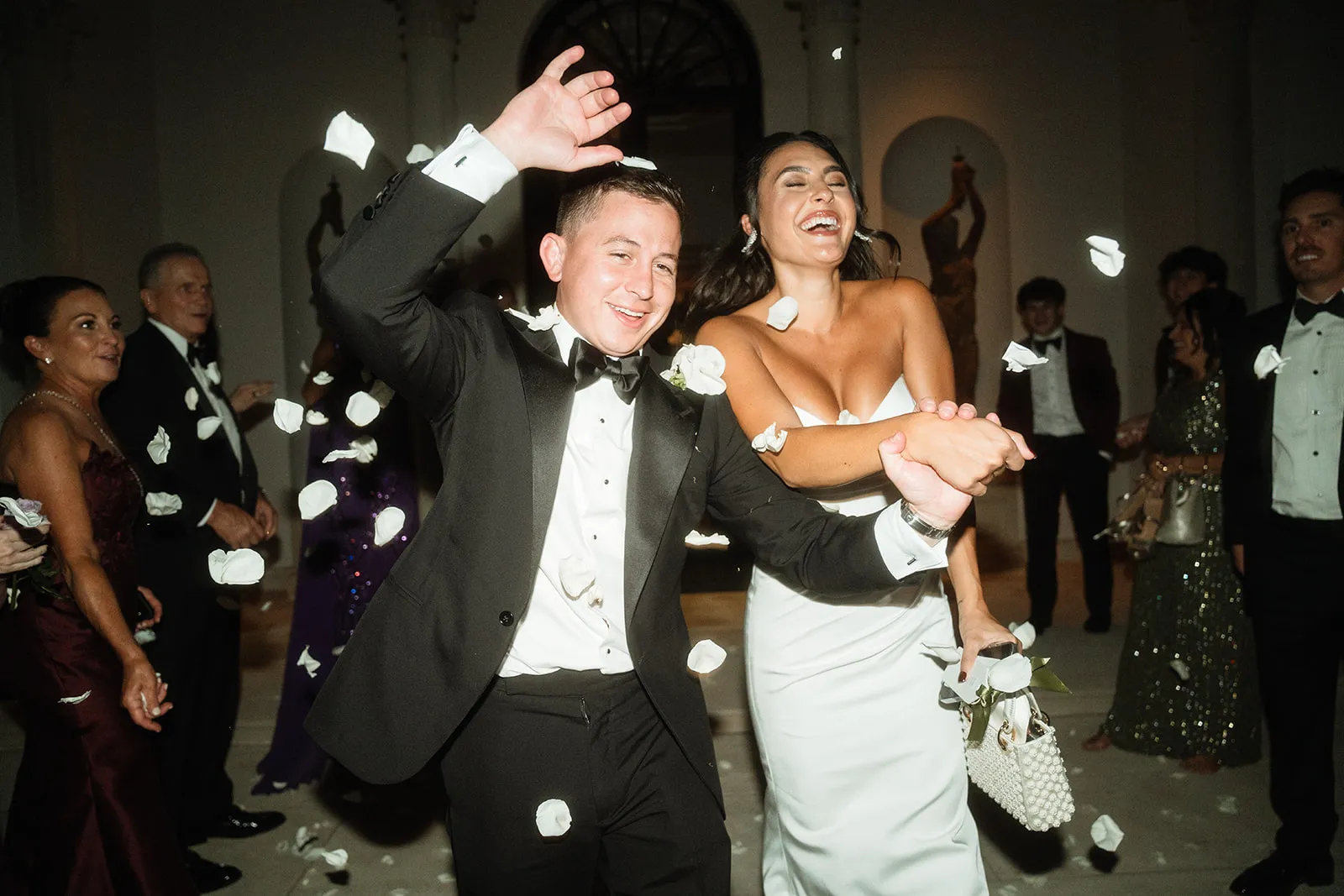 A bride and groom walking through a confetti send-off