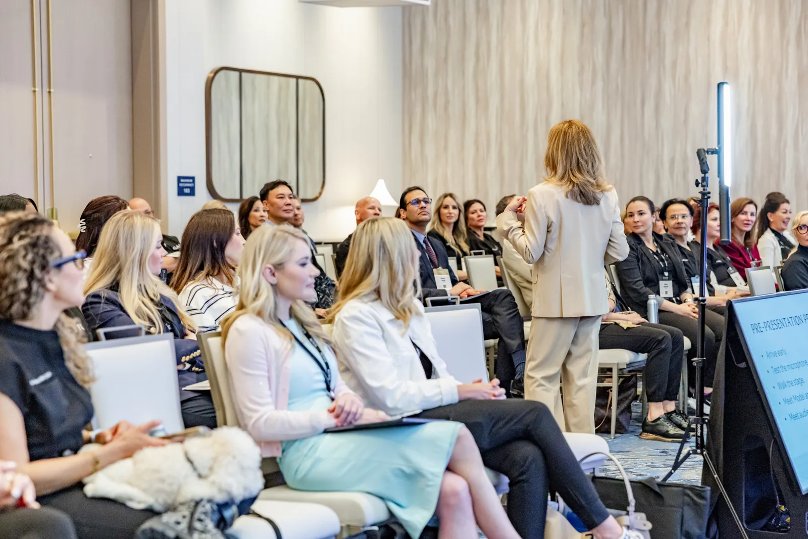 Guests seated for a presentation at a Poppy Planning corporate program