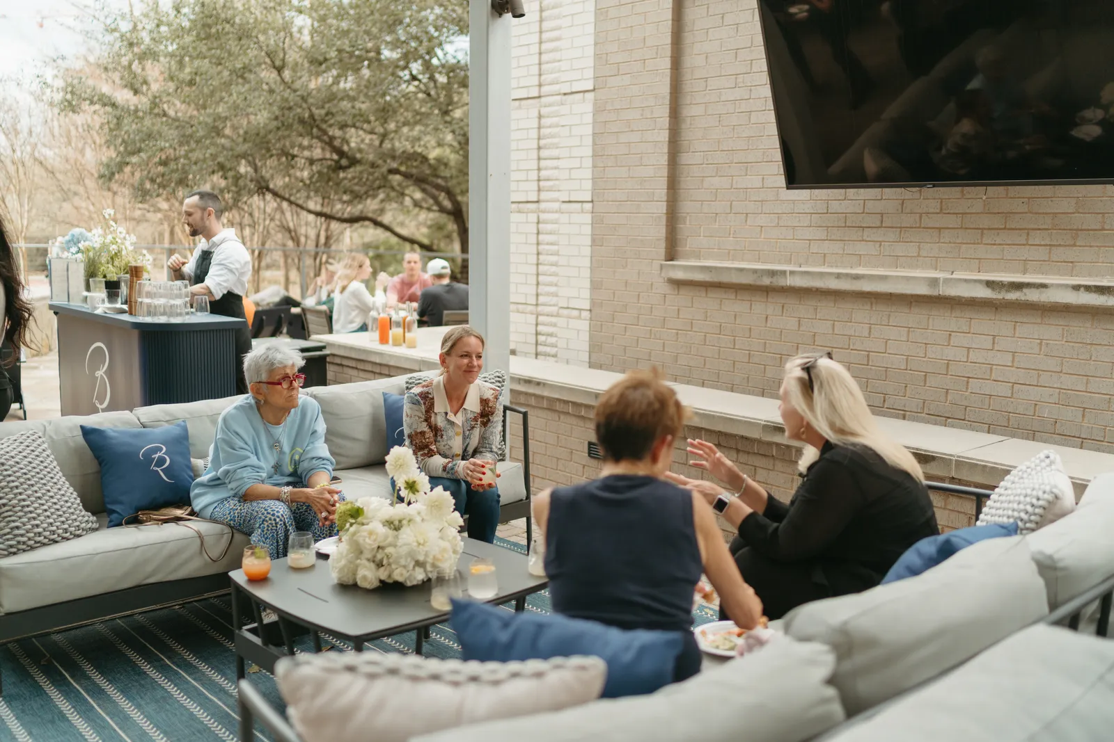 Guests talking on soft seating at a Poppy Planning event