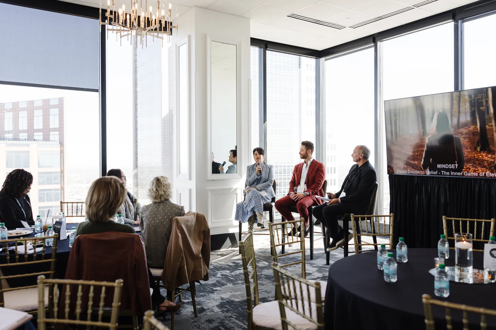 A panel session in a light-filled room at a Poppy Planning event